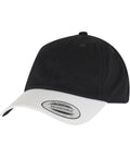 The Flexfit by Yupoong Low-profile cotton twill two-toned (6245CMT) cap features a black crown, white curved brim with a labelled tag, adjustable strap, and top button. Photographed on a white background.